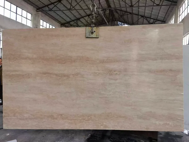 Warm beige slab with linear banding hanging from a clamp
