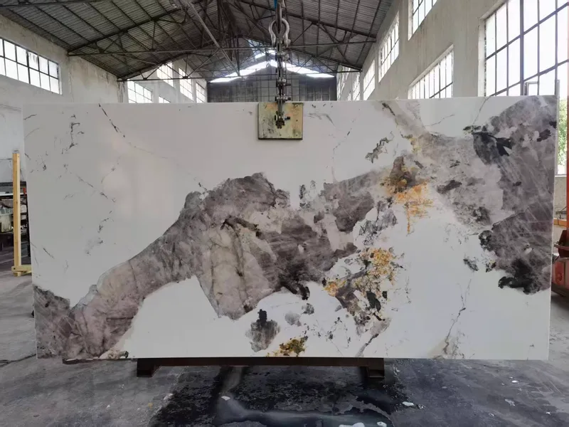 White slab with a large grey and gold pattern hanging from a clamp