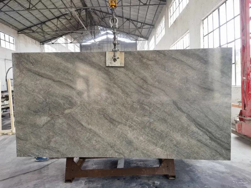 Grey-green slab with diagonal veining hanging from a clamp